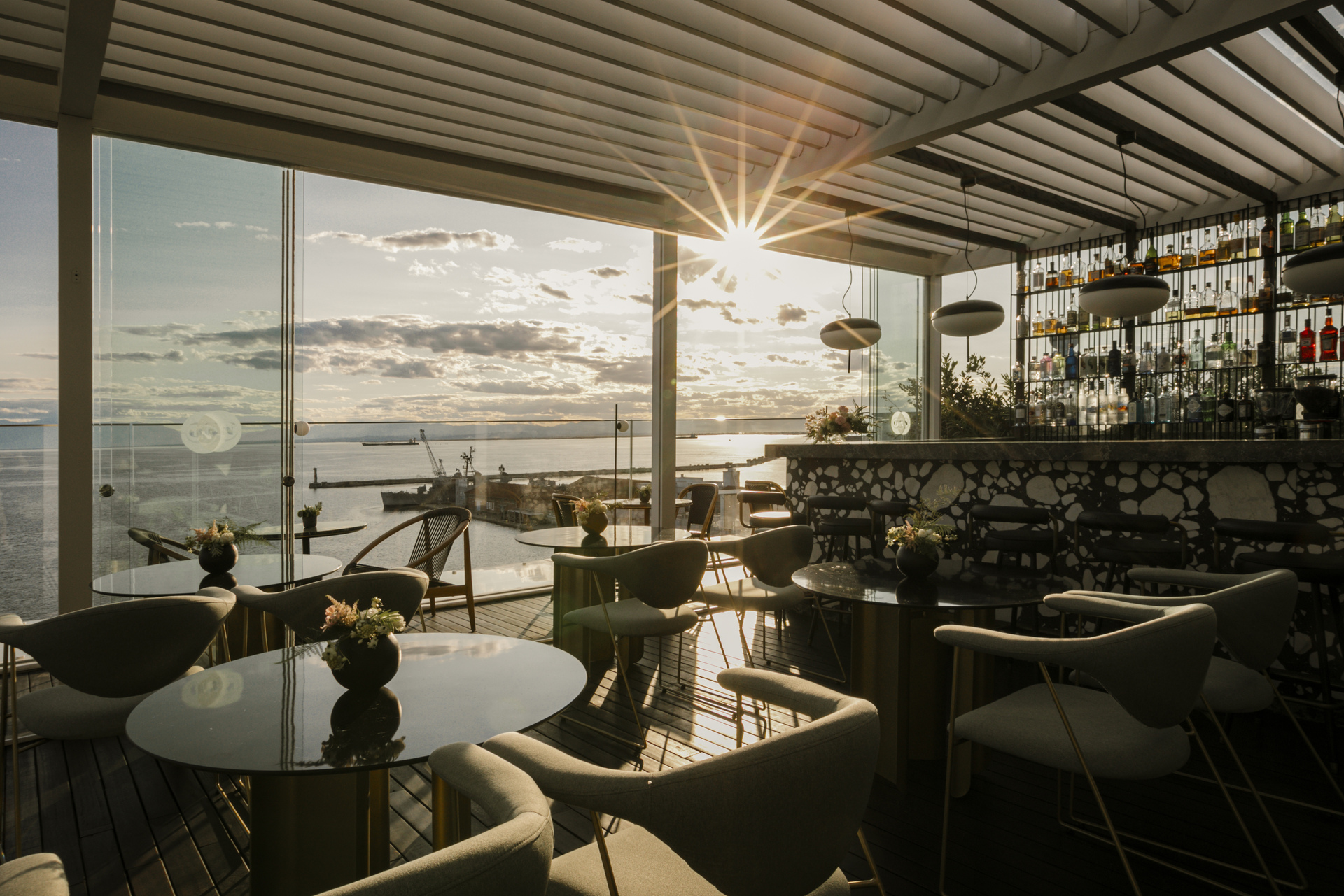 
Elegant ON Residence rooftop bar with sunset views, modern seating and cocktail setup