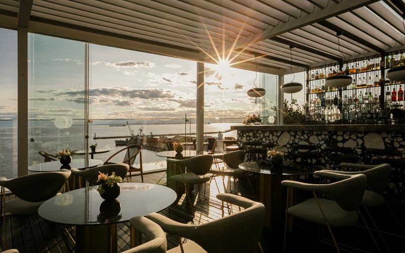 Elegant ON Residence rooftop bar with sunset views, modern seating and cocktail setup