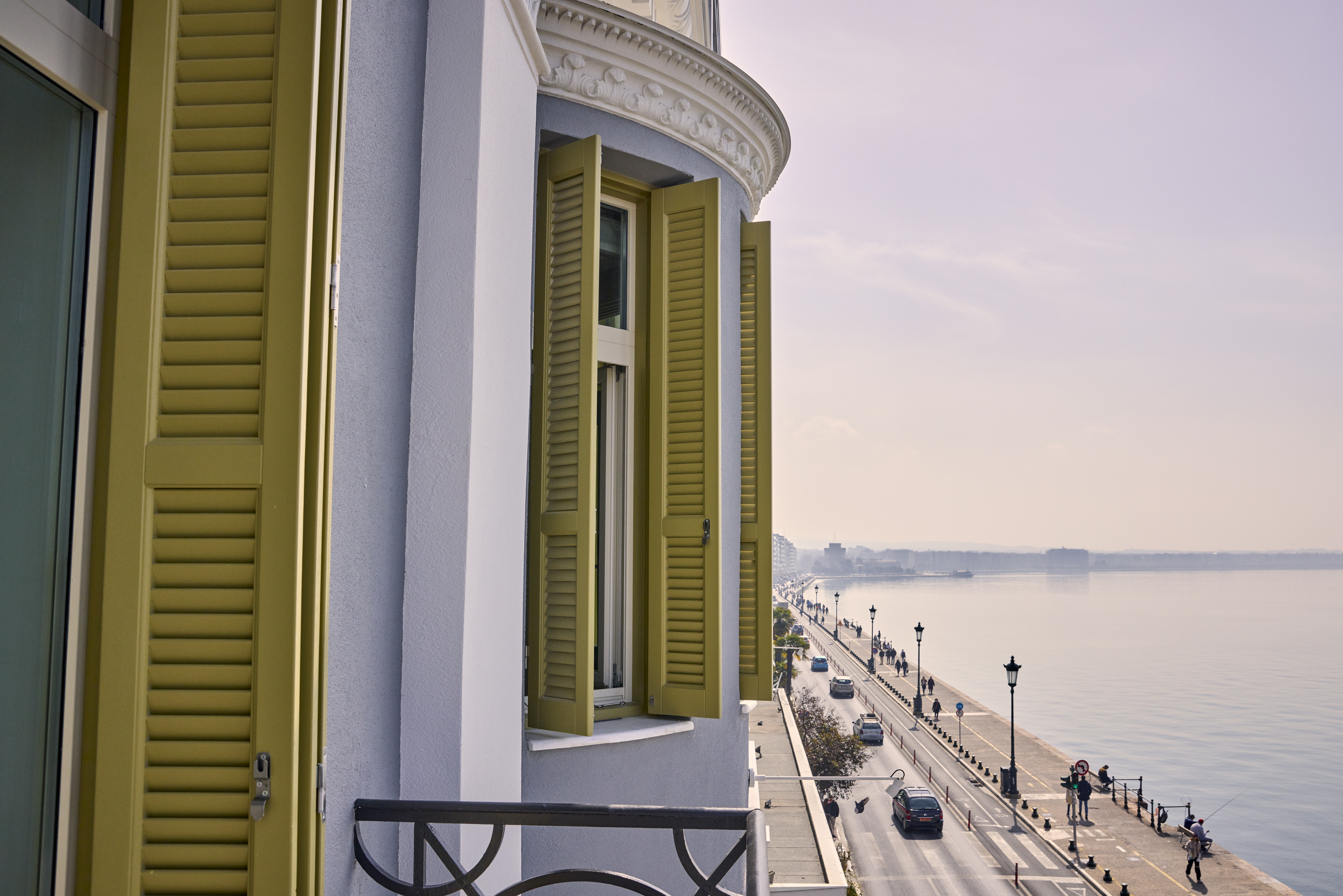 
ON Residence Hotel balcony with neoclassical shutters overlooking Thessaloniki seafront promenade