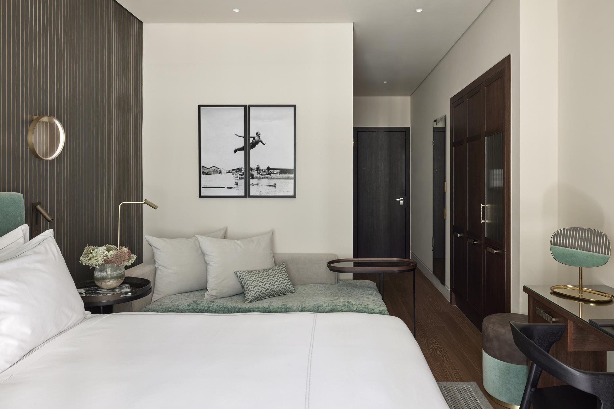 
Executive courtyard room with king bed, sofa, desk, modern lighting and wall art at ON Residence Hotel