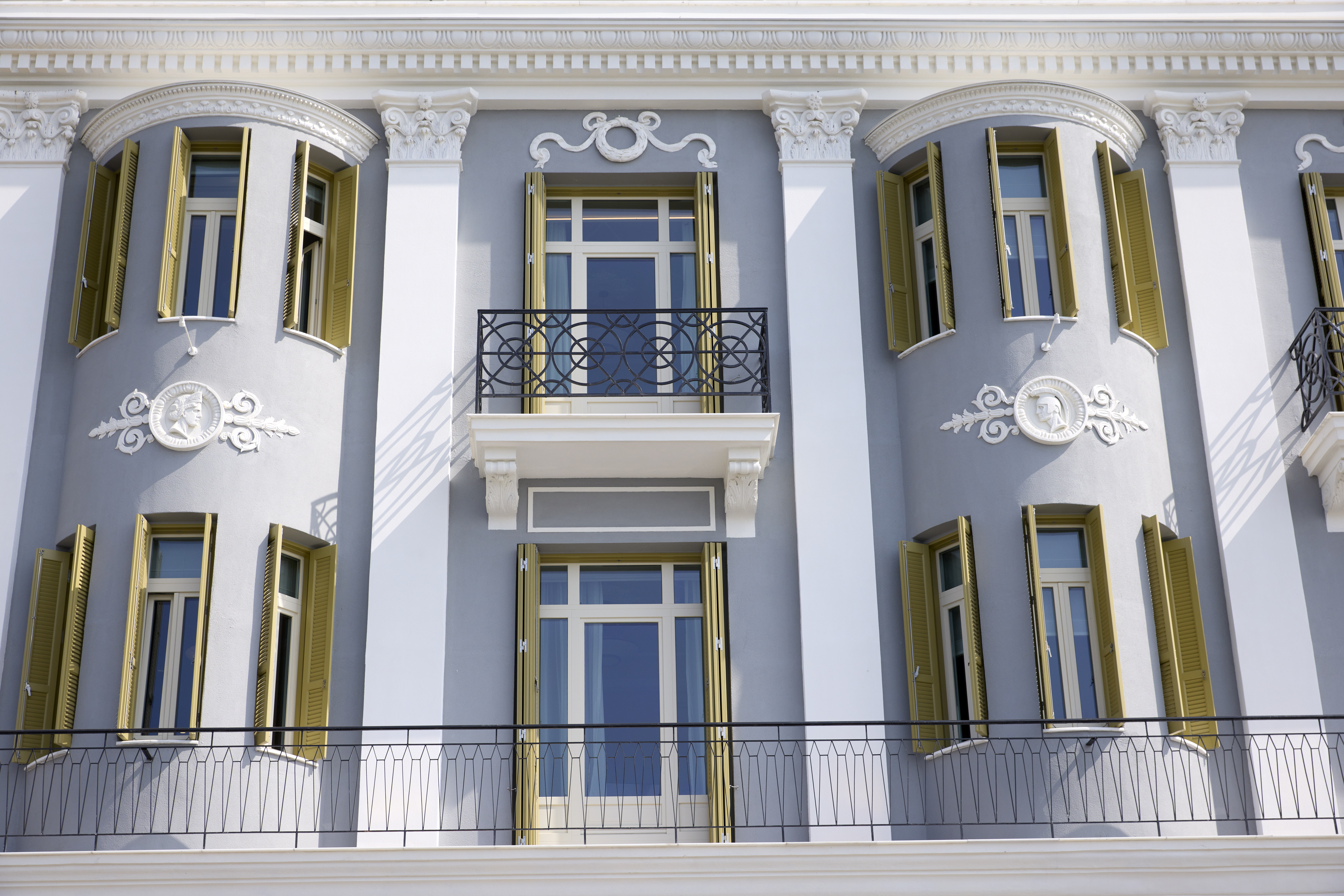 
ON Residence Hotel neoclassical facade with ornate balconies and shuttered windows 