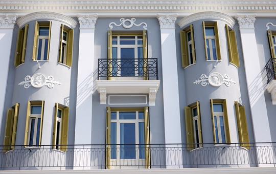 ON Residence Hotel neoclassical facade with ornate balconies and shuttered windows