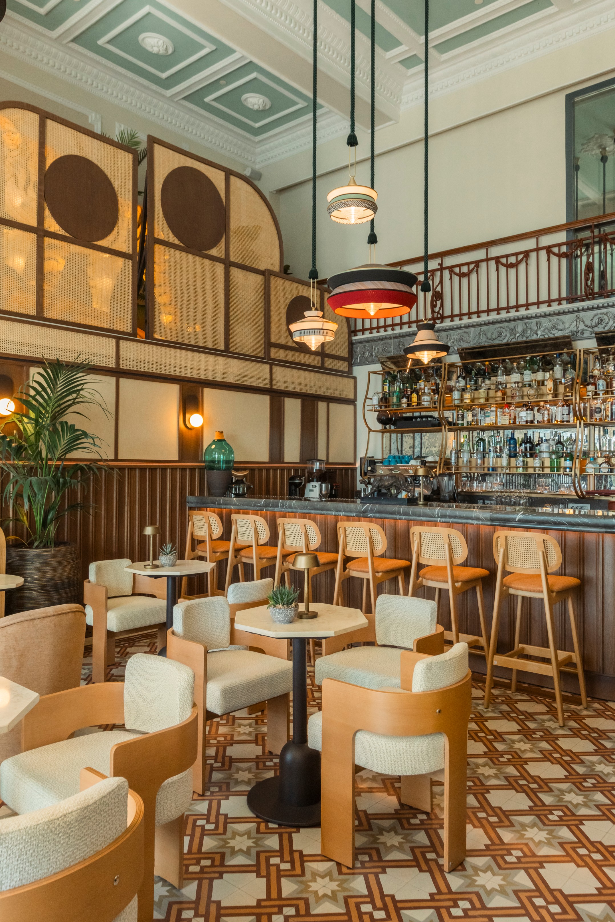 
Stylish bar area with patterned flooring, retro pendant lights, and wooden counter seating at Tiger Loop Bar