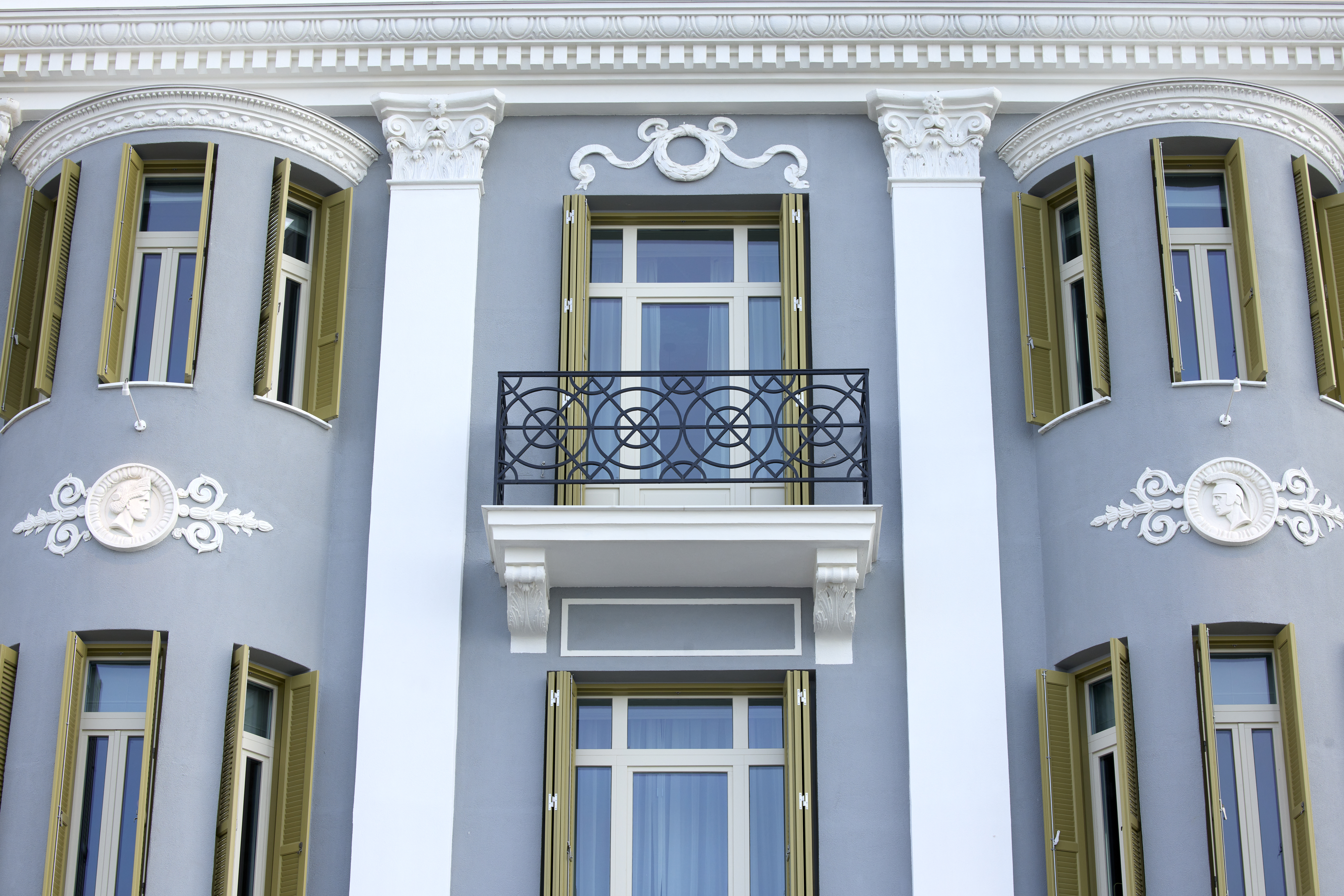 
ON Residence Hotel facade with neoclassical balcony, ornate details and arched windows