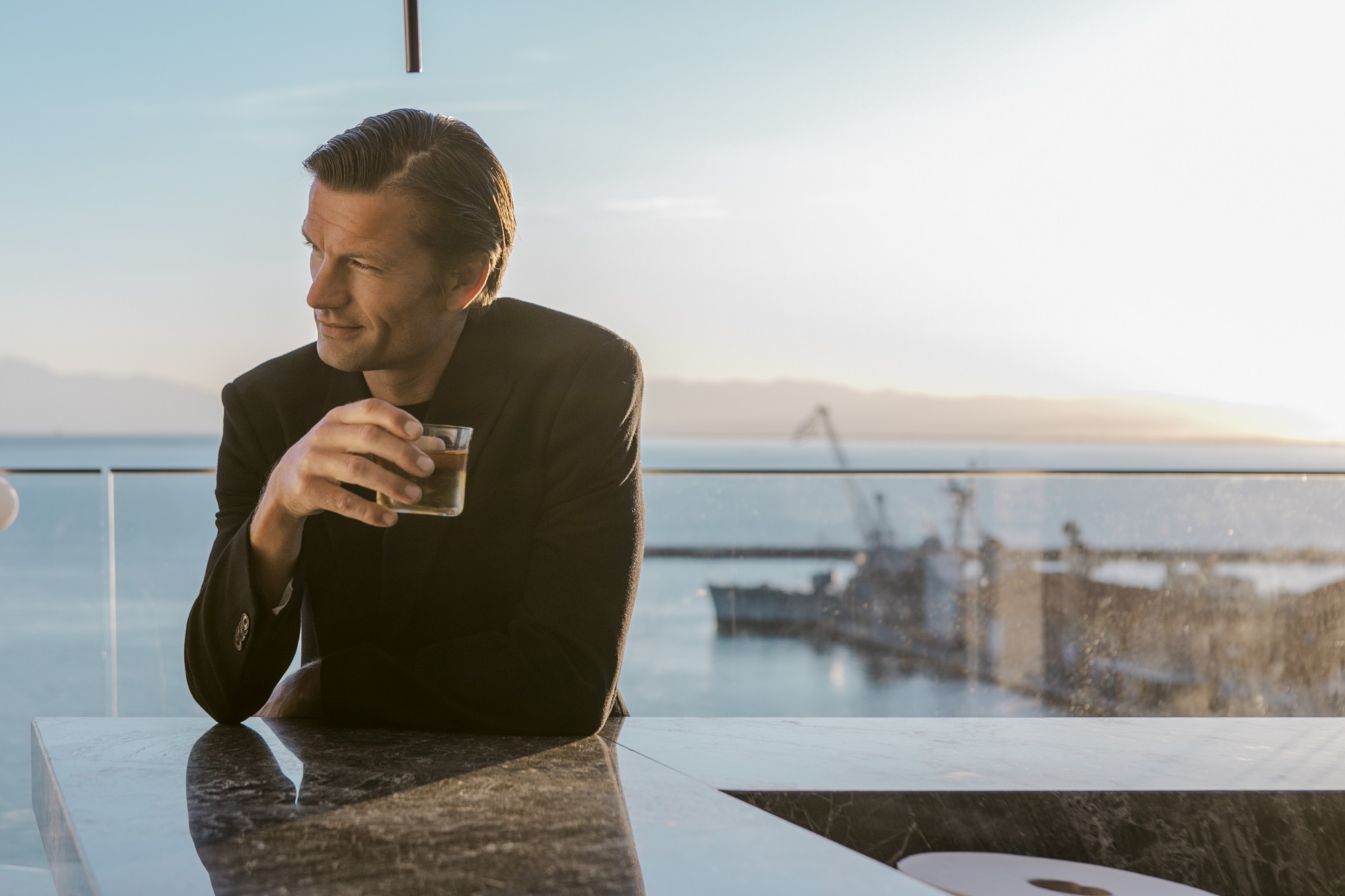 
Man enjoying a drink at sunset on ON Rooftop Bar terrace with sea view 