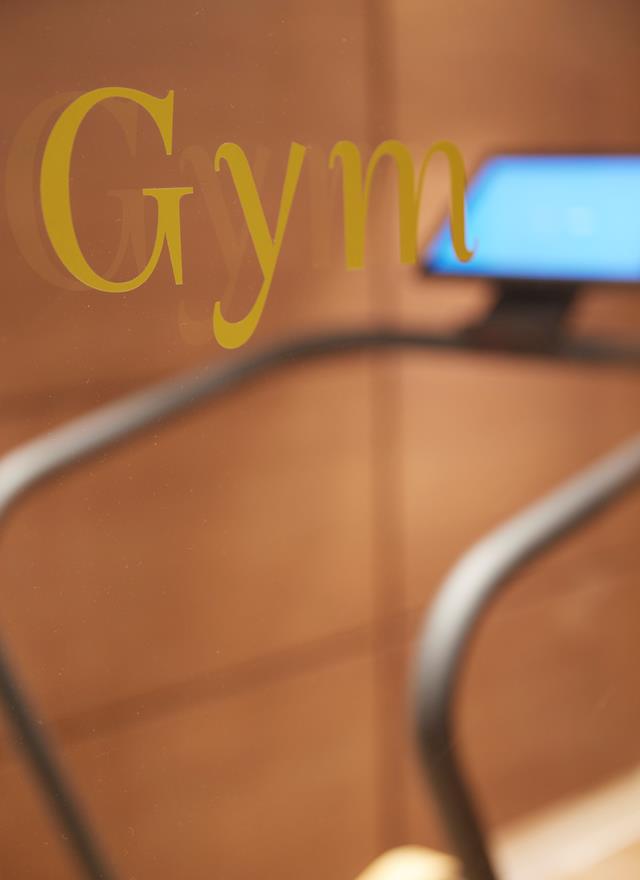 Entrance detail of the fitness room with glass door inscription at ON Residence Hotel