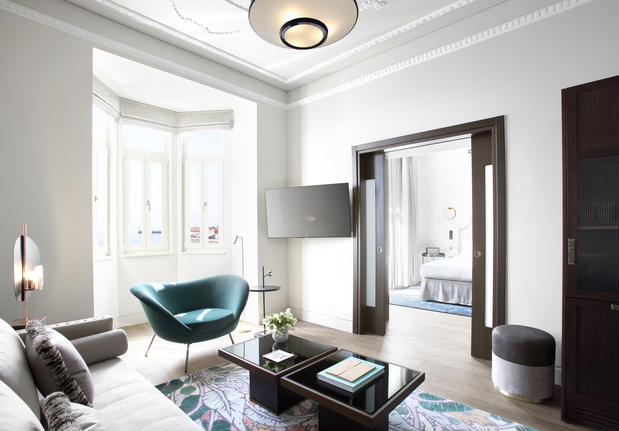 
Bright living room in Méditerranée Grand suite with teal armchair, modern decor and sea view at ON Residence Hotel