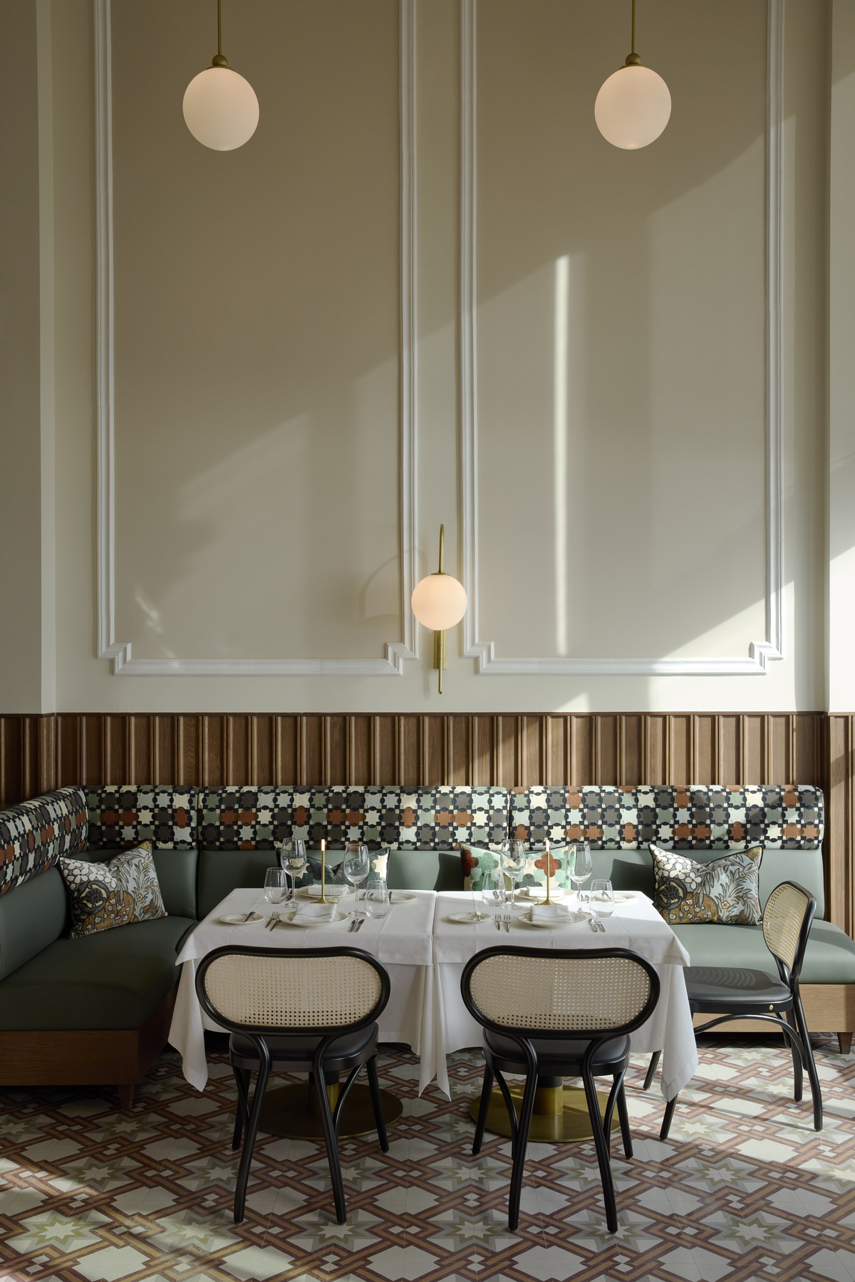 
Elegant restaurant corner with patterned seating, white tablecloth and vintage tiled floor at ON Residence Hotel